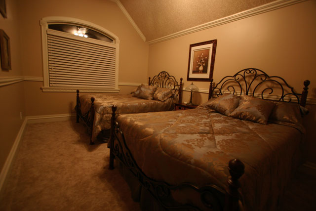 A private bedroom with two beds and warm lighting