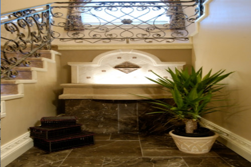 Entrance hall with wrought iron staircase and fountain