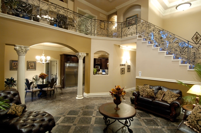 Double-height living room with leather seating and staircase