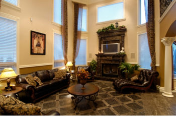 Sitting room with fireplace and leather armchairs